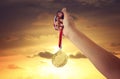 woman hand raised, holding gold medal against sky. award and victory concept. Royalty Free Stock Photo