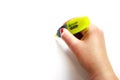 Woman hand with yellow highlighter on white background Royalty Free Stock Photo