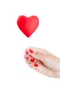 Woman hand with red nails holding heart Lollipop.