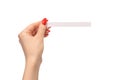 Woman hand with red nails with test strips for the perfume, isolated on a white background Royalty Free Stock Photo