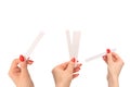 Woman hand with red nails with test strips for the perfume,  on a white background Royalty Free Stock Photo