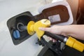 Woman hand refilling and pumping gasoline oil the car with fuel at he refuel station, industry or transportation concept Royalty Free Stock Photo