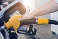 Woman hand refilling and pumping gasoline oil the car with fuel at he refuel station Royalty Free Stock Photo