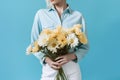 woman hand floral blue yellow bouquet flower romantic sweater present white. Generative AI. Royalty Free Stock Photo