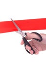 Woman hand with scissors cutting red ribbon Royalty Free Stock Photo