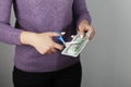 Woman hand scissors with money