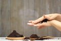 Woman hand with scrub coffee grounds on wooden background, Beauty and healthy care concept Royalty Free Stock Photo