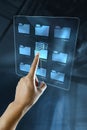 A woman hand is searching data in a folder on a digital screen