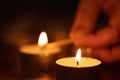 Woman hand setting candle close up