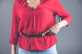 Woman hand in shirt belt