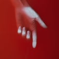 Woman hand showing direction down by finger in red blood water, cover for art in horror genre, detective novel, creative idea Royalty Free Stock Photo