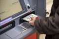 Woman hand showing dollar banknotes in front of the atm Royalty Free Stock Photo