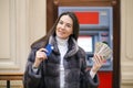 Woman hand showing dollar banknotes in front of the atm Royalty Free Stock Photo