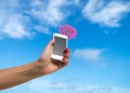 Woman hand showing mobile phone and cocktail umbrella on the sky Royalty Free Stock Photo