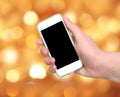 Woman hand showing smart phone with isolated screen on blurred c Royalty Free Stock Photo