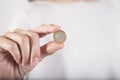 Woman hand showing worn Euro coin