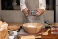 Woman Hand Sifting Bread Flour Before the Process of Kneading Dough