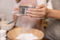 Woman Hand Sifting Bread Flour Before the Process of Kneading Dough