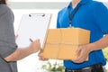 Woman hand signing receipt of delivered package. Delivery concept. Receiving package