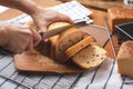 Woman hand slicing fresh baked cranberry bread loaf