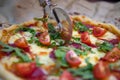 woman hand slicing pizza for pieces Royalty Free Stock Photo