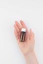 Woman hand with small glass bottle isolated Royalty Free Stock Photo