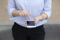 Woman hand smart phone in street