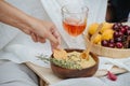 Woman hand smearing hummus on potato chip. Royalty Free Stock Photo