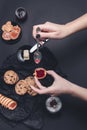 Woman hand with spoon jam and biscuits near cup of coffee or cappuccino chocolate cookies on black table background. Afternoon b Royalty Free Stock Photo