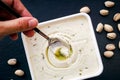 Woman hand with spoon taking pistachio ice cream from ice cream