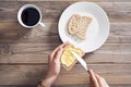 Woman hand spreading butter on sliced bread