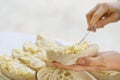 woman hand spreads bread with cheese salad with garlic. the process of preparing a snack for a grill party Royalty Free Stock Photo