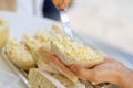 woman hand spreads bread with cheese salad with garlic. the process of preparing a snack for a grill party Royalty Free Stock Photo