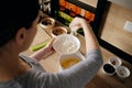 Woman hand sprinkling flour in a white bowl Royalty Free Stock Photo