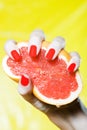 Woman Hand Squeezing a grapefruit