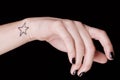 Woman hand with star tatoo