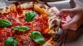 Woman Hand takes a slice of Pepperoni Pizza with Mozzarella cheese, salami, Tomatoes, pepper, Spices and Fresh Basil Royalty Free Stock Photo