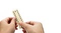 Woman hand taking birth control pills or contraceptive pills Royalty Free Stock Photo