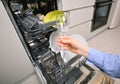 Woman hand taking clean drinking glass from the dishwasher Royalty Free Stock Photo