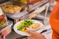 Woman hand taking food in buffet