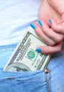 Woman hand taking money from jeans back pocket Royalty Free Stock Photo