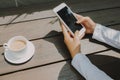 Woman hand texting for someone with black screen at coffee shop Royalty Free Stock Photo