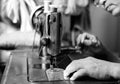 Woman hand threading needle into sewing machine needle Royalty Free Stock Photo