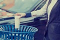 Woman hand throwing empty coffee cup in recycling bin Royalty Free Stock Photo