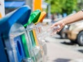 Woman hand throwing empty plastic water bottle in recycling bin. Royalty Free Stock Photo