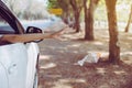 Woman hand throwing plastic bottle trash on the road,Environment and pollution campaign concept Royalty Free Stock Photo