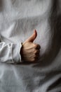 Woman hand with thumb up on a gray background Royalty Free Stock Photo