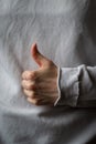 Woman hand with thumb up on a gray background Royalty Free Stock Photo