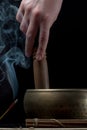 Woman hand with tibetan singing bowl and incense sticks Royalty Free Stock Photo