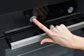 Woman hand touch control panel on electric oven in the kitchen Royalty Free Stock Photo